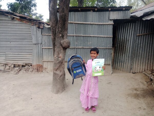 5. Khushi is happy to receive FH_s educational materials.jpg