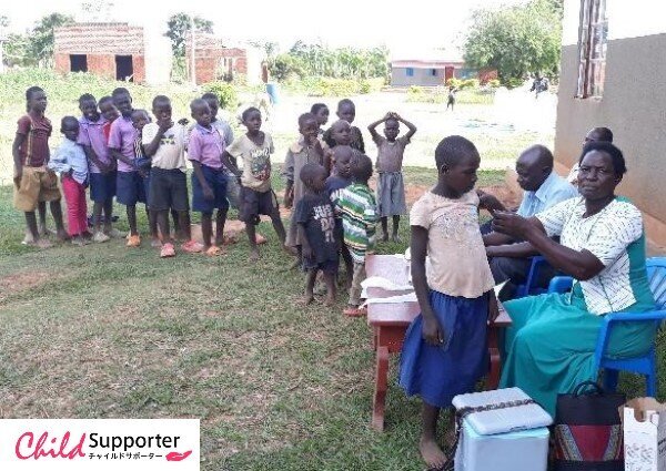 A nurse giving a girl TT vacine during child health days plus outreach.jpg