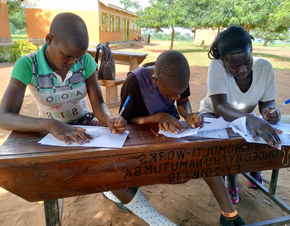 Children writing their correspondences.png